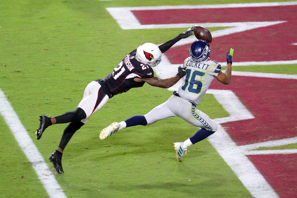 Tyler Lockett reels in a touchdown pass barely out of Cardinals cornerback Patrick Peterson's reach. 